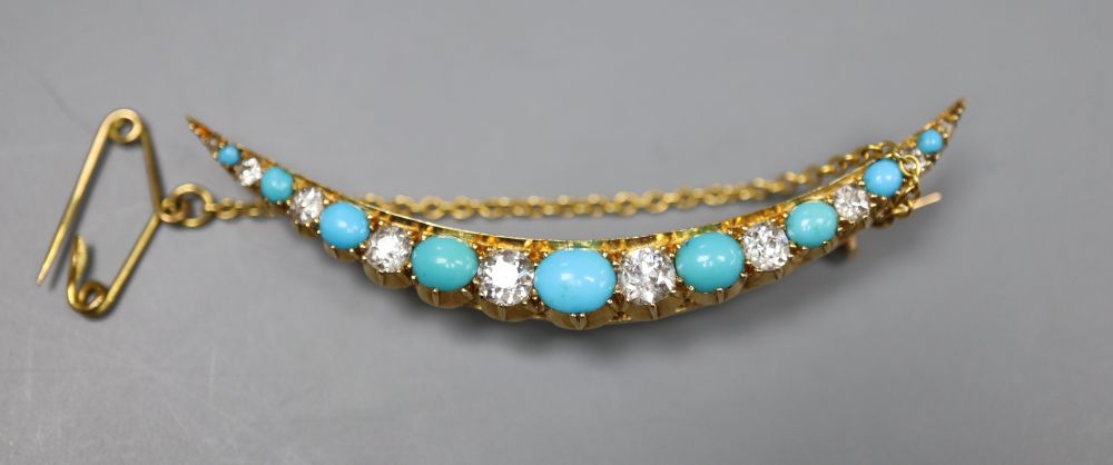 An Edwardian yellow metal, graduated turquoise and diamond set crescent brooch, 52mm, gross 5.3 grams.